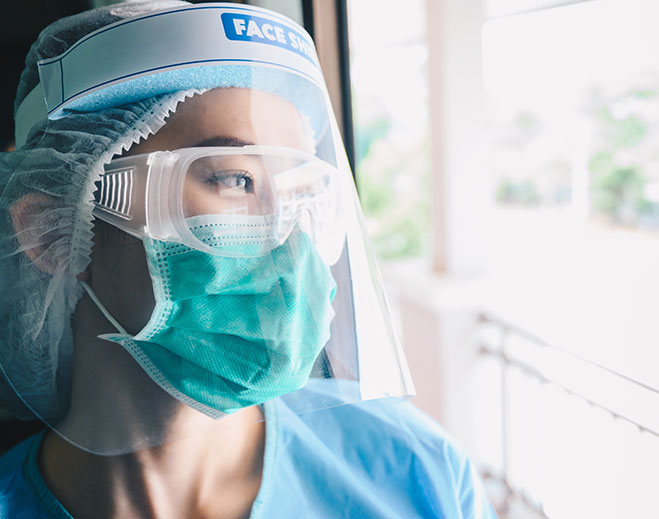 Healthcare worker wearing protective face shield