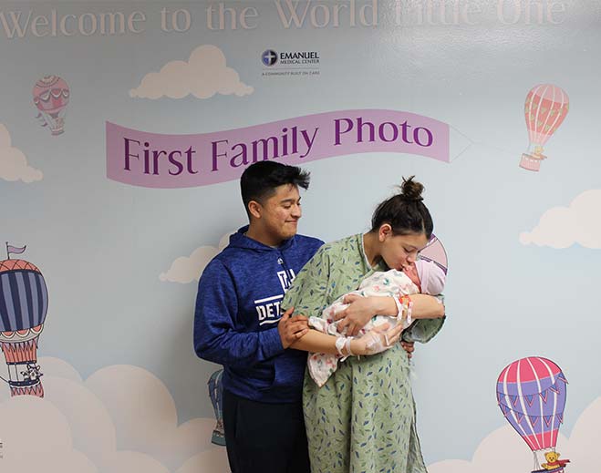 Family welcoming newborn baby at hospital