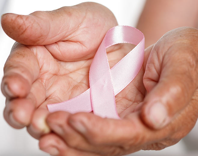 Breast cancer awareness ribbon in hands
