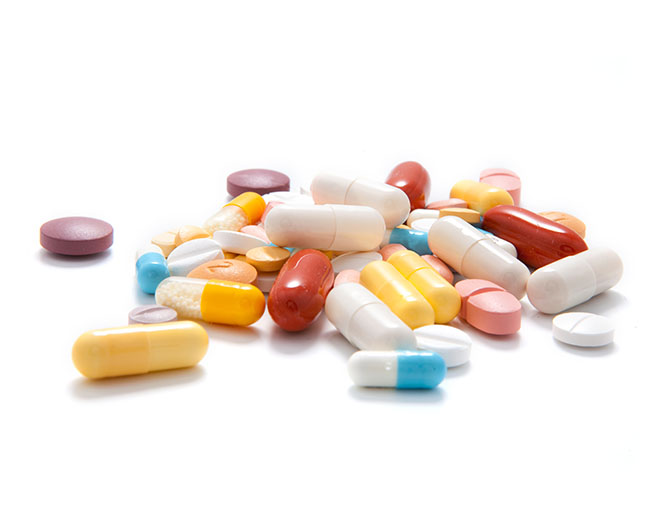 Assorted prescription pills on white background