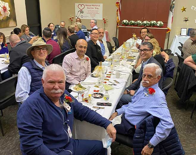 People seated at long banquet table