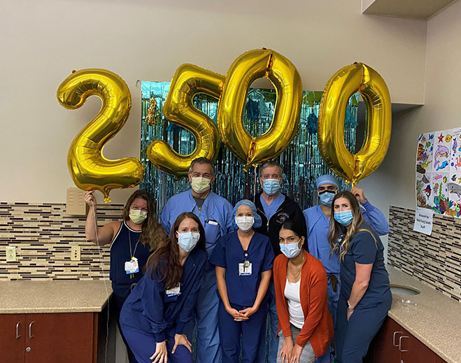 Healthcare team celebrating 2,500 robotic surgeries milestone