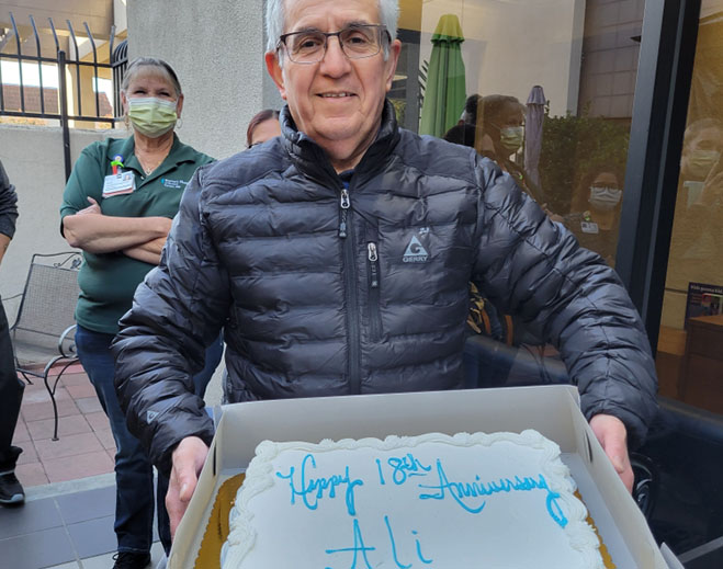 Employee celebrating eighteen-year work anniversary