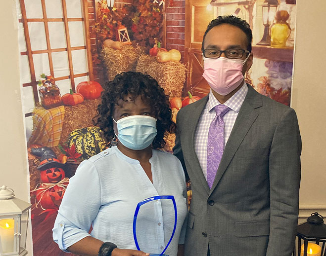 Healthcare leader presenting community service award