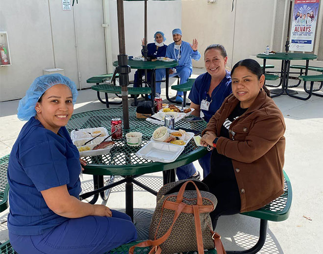 Hospital staff eating lunch outdoors together