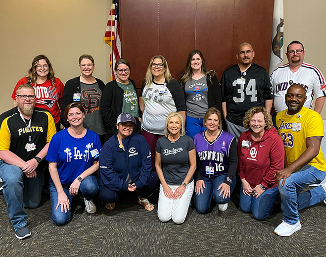 Group posing indoors wearing sports jerseys