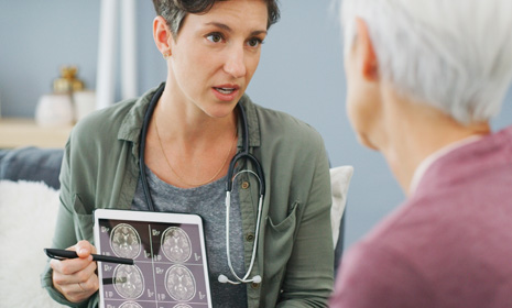 Clinician explaining brain scan to patient