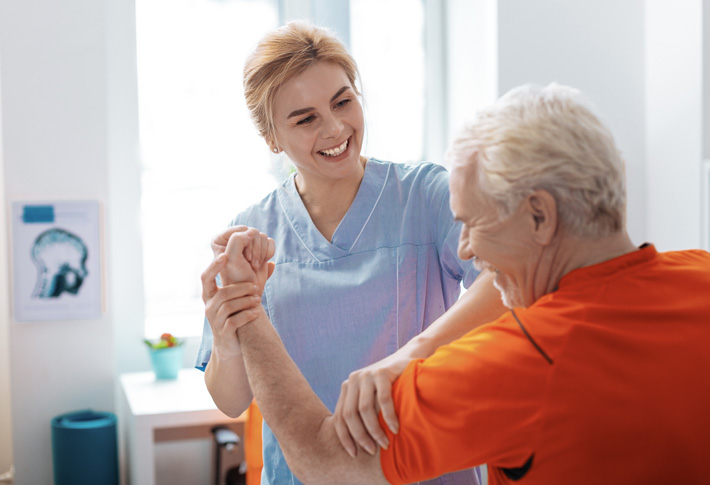 A doctor holds a tablet computer and discusses medical care options with a patient